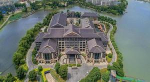a large house on an island in the water at Tong Que Tai Jinling Hotel Tongling Anhui in Tongling