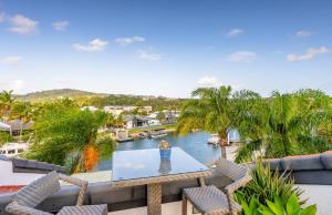 a view of the water from the balcony of a house at St Tropez 8 - Waterfront Retreat with Rooftop Spa & Sauna in Noosa Heads