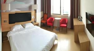 a hotel room with a white bed and red chairs at Thank Inn Hotel Jiangsu Suzhou Luzhi Ancient Town Scenic Area in Suzhou +36 photos
