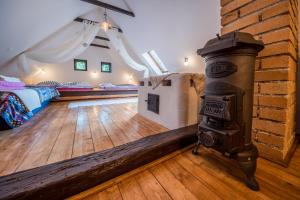 a room with a wood stove and a bedroom at Country House Fort Lacnov in Lipovce
