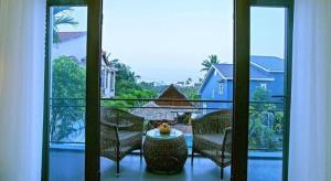 a view of a balcony with a table and chairs at Friendly Villa Hoian in Hoi An
