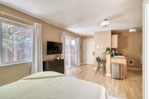 a bedroom with a bed and a large window at Stay Portland - Peaceful Johns Landing Studio - Near OHSU in Marquam Hill