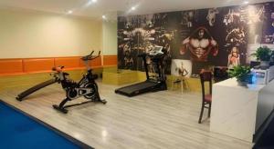 a room with a gym with exercise equipment on the floor at Shell Shanghai Songjiang District Xinqiao Town Xinqiao Hotel in Chunshen