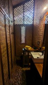 a small bathroom with a sink and a mirror at At Home in Puerto Princesa City