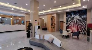 a lobby with a couch and a table in a building at GreenTree Inn Ganzhou Gan County Bus Station in Meilin