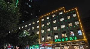 a large building with chinese writing in front of it at GreenTree Inn Ganzhou Gan County Bus Station in Meilin