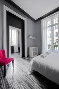 
a bedroom with a bed and a dresser at Hostal Boutique Khronos in Barcelona
