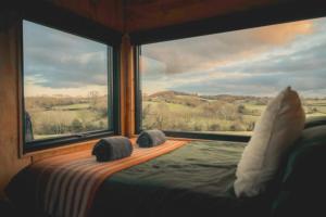 a bedroom with a large window looking out at the countryside at Altair in Holywell