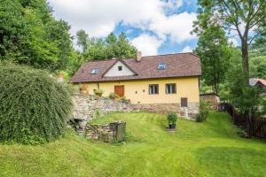a house on a hill with a stone wall at Country House Fort Lacnov in Lipovce