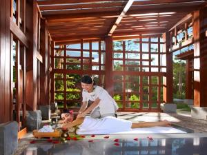 a woman laying on a bed in a pool at Fliport Hotel Zhangzhou Yuanshan in Zhangzhou