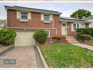 a brick house with a driveway and a garage at Belmont Lux Escape - Walkable Studio 19 Miles to Manhattan in Elmont