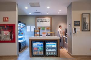 a man standing at a counter in a store at Candlewood Suites - Guadalajara Galerias by IHG in Guadalajara