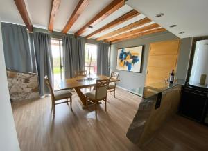 a dining room with a table and chairs and a television at Villa Bella vista 2024 in San Rafael