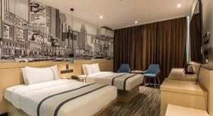 a hotel room with two beds and a desk at City Comfort Inn Guilin Railway Station in Guilin