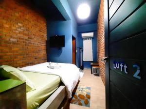 a bedroom with a bed and a brick wall at The Royal Chiangkhan Boutique Hotel in Chiang Khan +167 photos