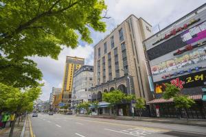 a street in a city with tall buildings at Business Design Hotel LUV in Incheon