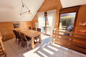 a dining room with a wooden table and chairs at Chalet T3 with garden in Xonrupt-Longemer in Xonrupt-Longemer