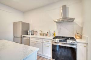 a kitchen with a stove and a refrigerator at Stay Portland - Historic Queen Anne Vernacular - 95 WalkScore in Portland
