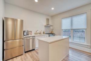 a kitchen with a stainless steel refrigerator at Stay Portland - Historic Queen Anne Vernacular - 95 WalkScore in Portland