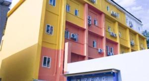 a multicolored building with a building at 7 Days Inn Changsha Pedestrian Street Nanmenkou Metro Station in Changsha