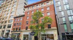 a tree in front of a red brick building at The Oxford Seattle-Downtown in Seattle
