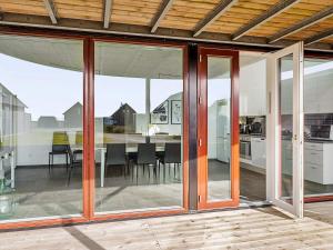 an open kitchen and dining room with sliding glass doors at Luxury Golf View Retreat - By Traum Ferienwohnungen in Sønderby