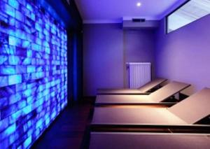 a waiting room with a large screen television at Locanda In Borgo Garnì & Wellness in Borgo