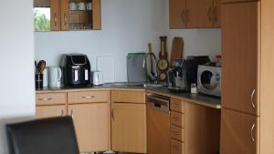 a kitchen with wooden cabinets and a sink and a microwave at Restful Haven 