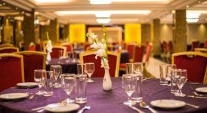 a purple table with glasses and a vase with flowers at Hotel Castle Salam in Khulna +48 photos