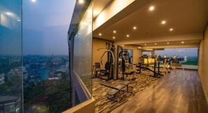 an exercise room with a view of a city at Hotel Castle Salam in Khulna