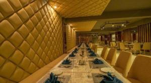 a long dining room with a long table with chairs at Hotel Castle Salam in Khulna