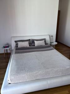 a large white bed in a white room at Room Korunní dvur in Prague