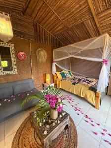 a room with a bed and a table with flowers at LE CHISSIOUA in Sada