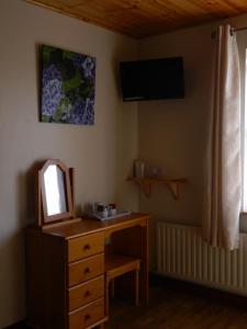 a bathroom with a wooden dresser and a mirror at Doolin House in Doolin