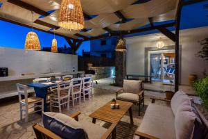 a patio with a bar and tables and chairs at Bougan Villa in Lartos