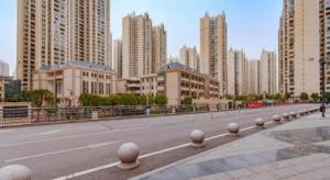 an empty street in a city with tall buildings at Echarm Hotel Guiyang International Convention & Exhibition Center in Guiyang