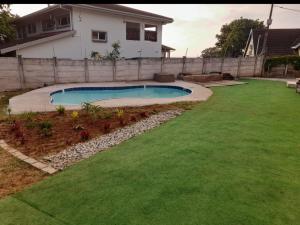 a backyard with a swimming pool in a yard at Ocean Wave Chalets Unit 2 in Hibberdene