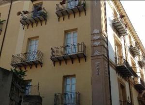 a tall building with balconies on the side of it at Terrazze Ginevra in Palermo
