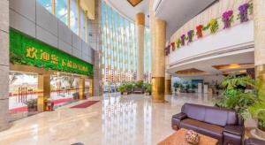 a lobby of a shopping mall with a large building at Maihao International Hotel in Zhuhai