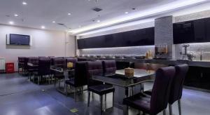 a bar in a restaurant with chairs and a counter at Yitel Beijing Tuanjiehu Metro Station in Beijing