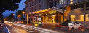 a city street with cars parked in front of buildings at Subic Grand Harbour Hotel Subic Bay in Olongapo