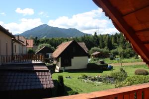 vistas a un patio con una casa y una montaña en Apartman Matej, en Liptovský Mikuláš