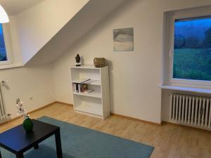 a living room with a table and a window at Oberdorf in Konstanz