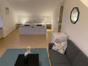 a living room with a couch and a bed at Oberdorf in Konstanz