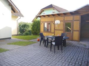 a patio with a table and chairs and a building at Villa Frymburk in Frymburk