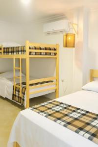 a bedroom with two bunk beds and a lamp at Sol Coral in Valdivia