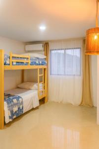a bedroom with two bunk beds and a window at Sol Coral in Valdivia