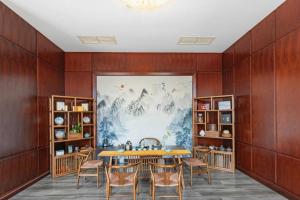 a dining room with a table and chairs at New Century Pujiang Hotel in Xiajizhai