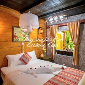 a bedroom with a bed with two stuffed animals on it at Memories Hoi An Villa in Hoi An