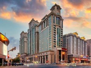 a large building with a clock tower in a city at Lavande Hotel Tianjin Youyi Road Xiaobailou 5th Avnue in Tianjin